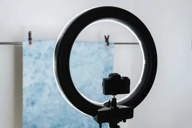 Contemporary photo camera and studio lamp prepared for photo session in professional studio. How to pick a beauty creator partnerships survey sample